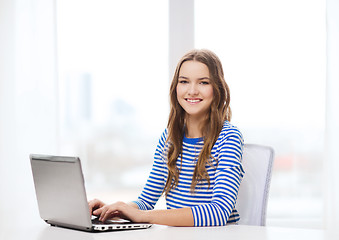 Image showing smiling teenage gitl with laptop computer at home