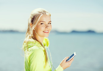 Image showing woman listening to music outdoors