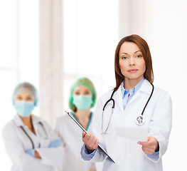 Image showing calm female doctor with clipboard