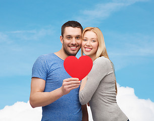 Image showing smiling couple holding big red heart