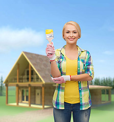 Image showing smiling woman with paintbrush