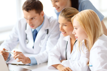 Image showing group of doctors looking at laptop computer