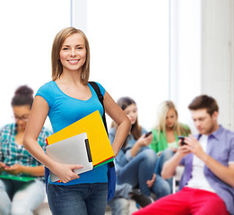 Image showing smiling student with bag, folders and tablet pc