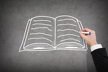 Image showing close up of businessman drawing book