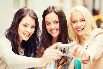 Image showing beautiful girls taking picture in cafe in city
