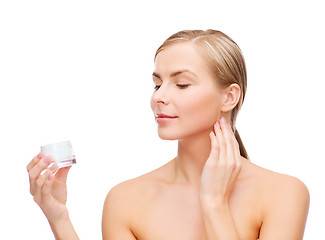 Image showing woman applying cream on her skin