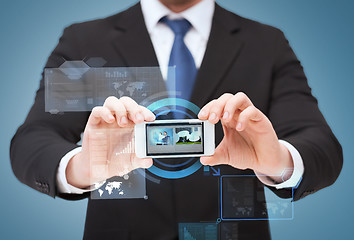 Image showing businessman showing smartphone with blank screen