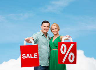 Image showing smiling couple with shopping bags