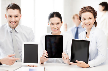 Image showing business team showing tablet pcs in office