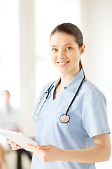 Image showing smiling female doctor or nurse with tablet pc