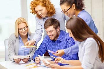 Image showing smiling team with color samples at office