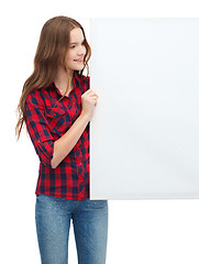 Image showing smiling young teenage girl with white blank board