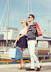 Image showing young couple in duty free shopping bags