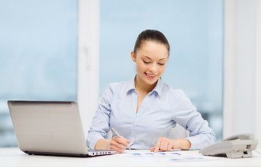 Image showing businesswoman with phone, laptop and files