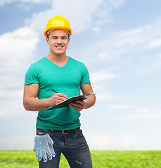 Image showing smiling man in helmet with clipboard