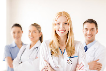 Image showing female doctor or nurse in front of medical group