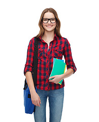 Image showing smiling female student with bag and notebooks