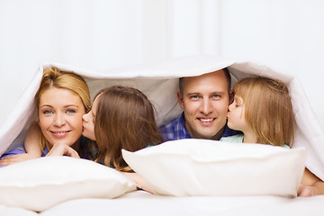 Image showing two little girls kissing their parents on cheek