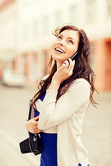 Image showing girl with phone, tourist book and vintage camera