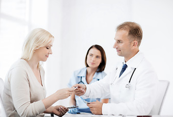 Image showing doctor giving tablets to patient in hospital