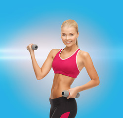 Image showing young sporty woman with light dumbbells