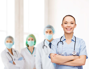 Image showing smiling female doctor or nurse with stethoscope