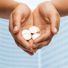 Image showing womans cupped hands showing euro coins