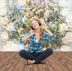 Image showing young woman listeting to music with headphones