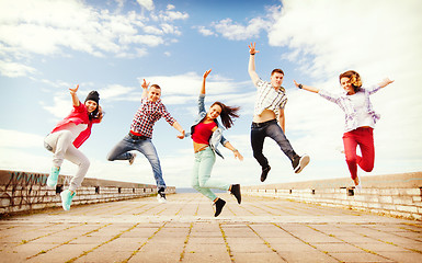 Image showing group of teenagers jumping