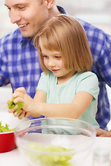 Image showing smiling father and little girl at kitchen