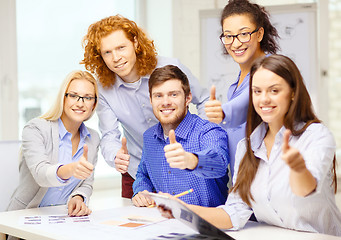 Image showing creative team with papers showing thumbs up