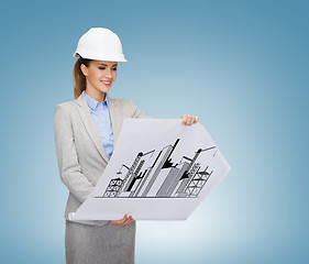 Image showing smiling architect in white helmet with blueprints