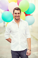 Image showing man with colorful balloons in the city