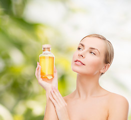 Image showing lovely woman with oil bottle