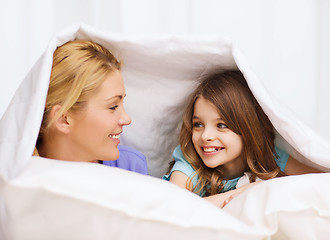 Image showing mother and little girl under blanket at home