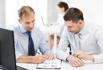 Image showing businessmen with notebook on meeting