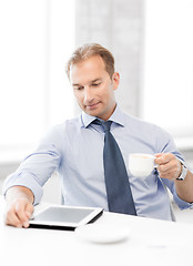 Image showing businessman with tablet pc and coffee in office