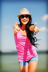 Image showing girl showing thumbs up on the beach