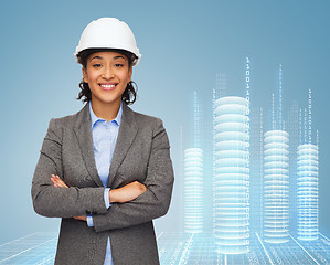 Image showing businesswoman in white helmet with crossed arms