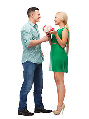 Image showing smiling couple with flower bouquet