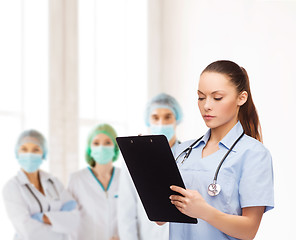 Image showing serious female doctor or nurse with stethoscope