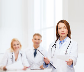 Image showing calm female doctor with clipboard