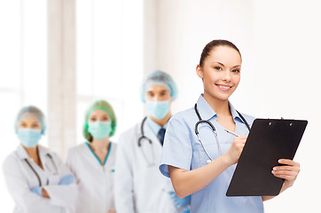 Image showing smiling female doctor or nurse with stethoscope