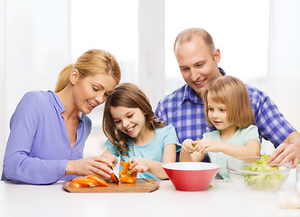 Image showing happy family with two kids making dinner at home