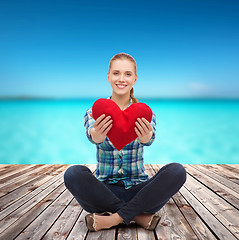 Image showing young woman in casual clothes sitting on floor