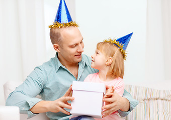 Image showing father and daughter in blue hats with gift box