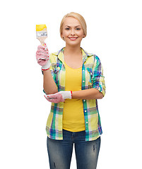 Image showing smiling woman with paintbrush