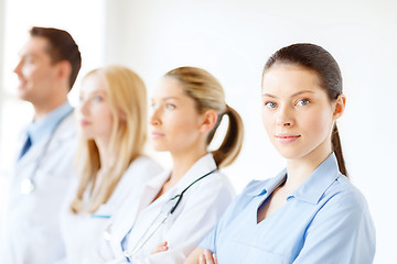 Image showing female doctor or nurse in front of medical group