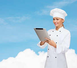 Image showing smiling female chef with tablet pc computer