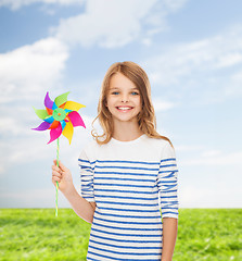 Image showing smiling child with colorful windmill toy